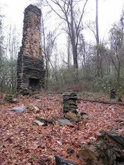 Stone chimney in the woods at Camp Highland